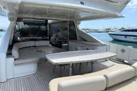 Luxurious 2006 Azimut 86S yacht with spacious outdoor seating and dining area.