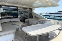 Luxurious 2006 Azimut 86S yacht with elegant outdoor seating and dining area.