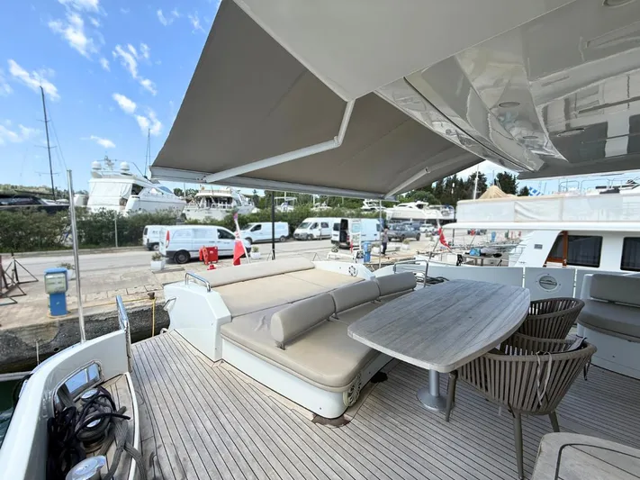  Yacht Photos Pics Luxury yacht deck with seating and table, Azimut 86S, 2006 model, docked at marina.