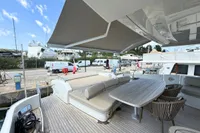 Luxury yacht deck with seating and table, Azimut 86S, 2006 model, docked at marina.