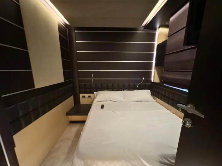  Yacht Photos Pics Luxurious bedroom interior on a 2006 Azimut 86S yacht, featuring modern design and cozy bedding.