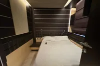 Luxurious bedroom interior on a 2006 Azimut 86S yacht, featuring modern design and cozy bedding.