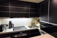 Modern kitchen interior on a 2006 Azimut 86S yacht, featuring sleek black cabinetry.