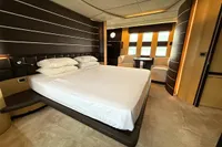 Luxurious bedroom interior of 2006 Azimut 86S yacht with modern design and elegant furnishings.