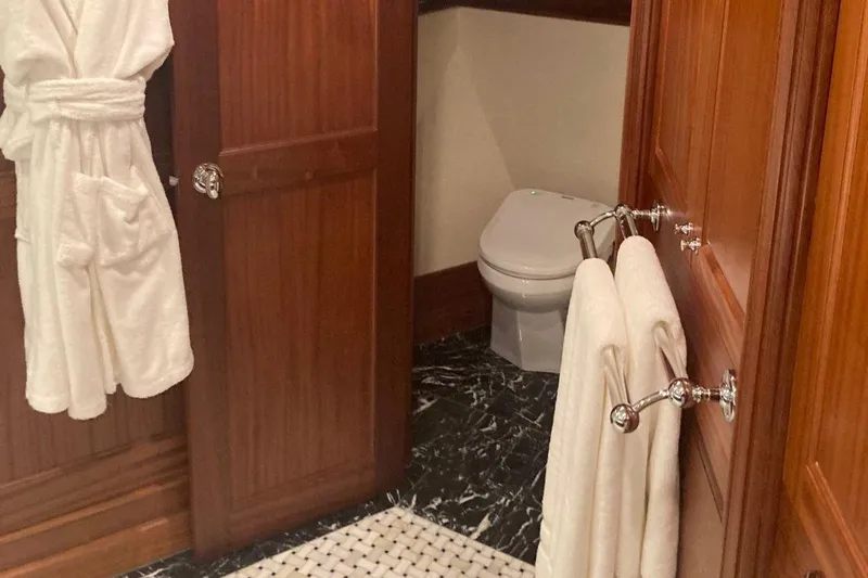 Allseas Yacht Photos Pics Luxurious bathroom in 2016 Allseas Expedition 92 yacht with wooden cabinets and marble flooring.