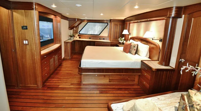 Allseas Yacht Photos Pics Luxurious master bedroom on the 2016 Allseas Expedition 92 yacht with wooden interiors.