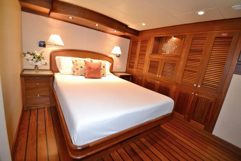 Allseas Yacht Photos Pics Luxurious bedroom on the 2016 Allseas Expedition 92 yacht with wooden decor.