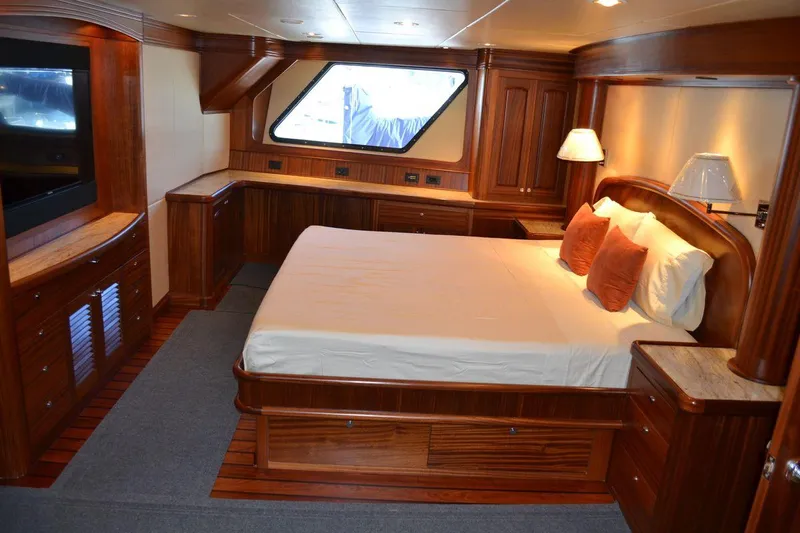 Allseas Yacht Photos Pics Luxurious master bedroom on the 2016 Allseas Expedition 92 yacht with wooden furnishings.