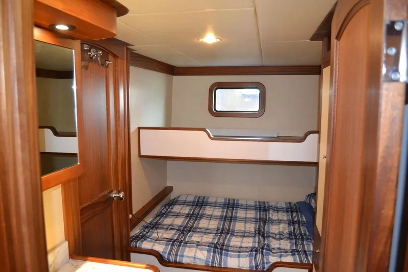 Allseas Yacht Photos Pics 2016 Allseas Expedition 92 cabin with bunk beds and wooden interior.