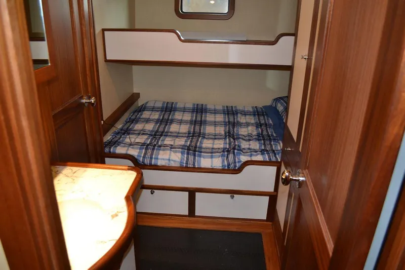 Allseas Yacht Photos Pics 2016 Allseas Expedition 92 cabin with bunk beds and plaid bedding.