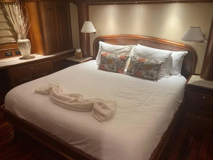 Allseas Yacht Photos Pics Luxurious bedroom on 2016 Allseas Expedition 92 yacht with elegant wooden decor.