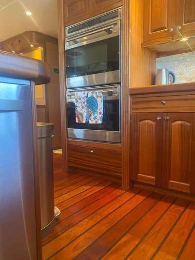 Allseas Yacht Photos Pics Modern kitchen in Allseas Expedition 92 yacht, 2016 model, featuring stainless steel appliances and wooden cabinetry.