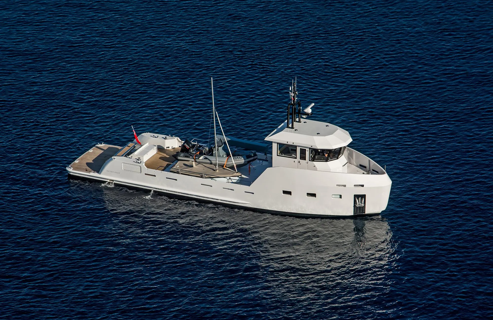 2027 Outer Reef Yachts 20 YXT on calm blue water, showcasing sleek design and modern features.