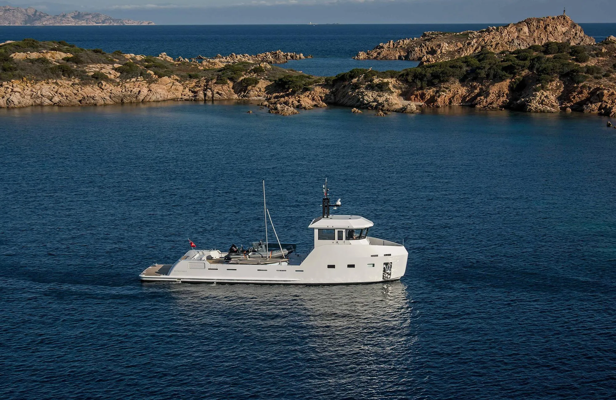 Outer Reef Yachts 20 YXT 2027 cruising in scenic coastal waters.
