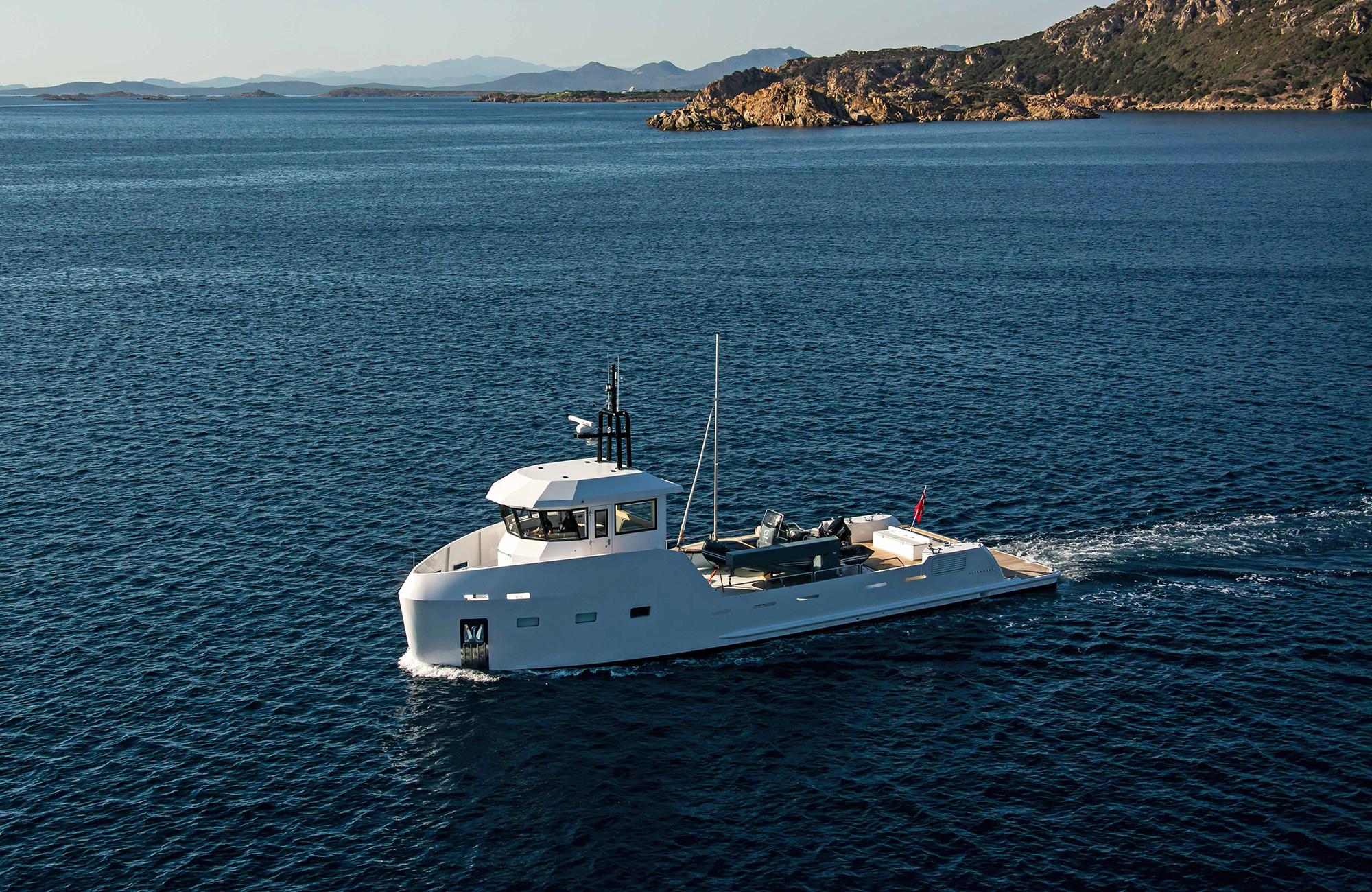 2027 Outer Reef Yachts 20 YXT cruising on open sea near rocky coastline.