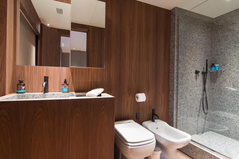 Whisper V Yacht Photos Pics Luxurious bathroom on 2002 Ferretti Yachts 112 Custom Line with wood accents and modern fixtures.