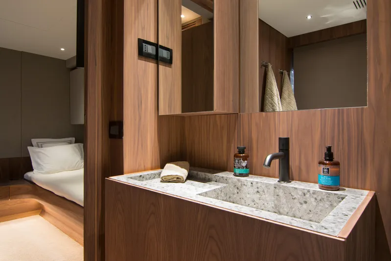 Whisper V Yacht Photos Pics Luxurious bathroom interior on a 2002 Ferretti Yachts 112 Custom Line, featuring wood accents and modern fixtures.
