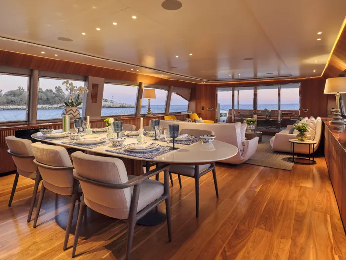 Whisper V Yacht Photos Pics Luxurious interior of 2002 Ferretti Yachts 112 Custom Line, featuring elegant dining and seating areas.