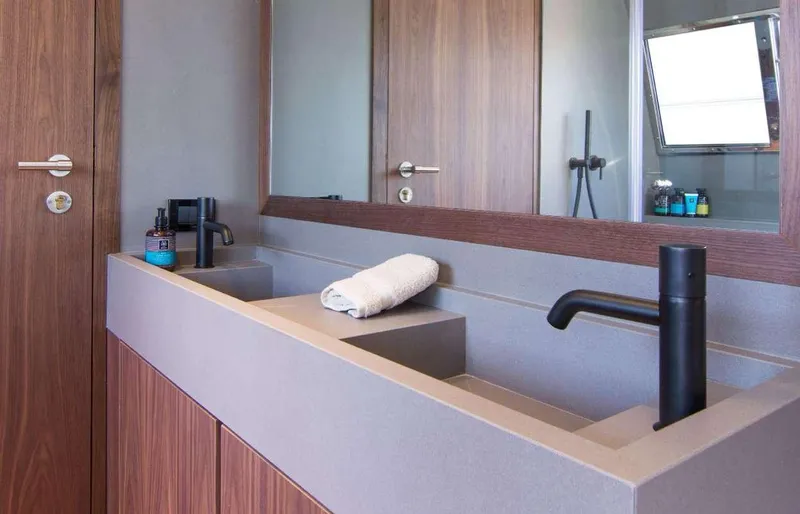 Whisper V Yacht Photos Pics Modern bathroom sink on 2002 Ferretti Yachts 112 Custom Line, featuring sleek design and black fixtures.