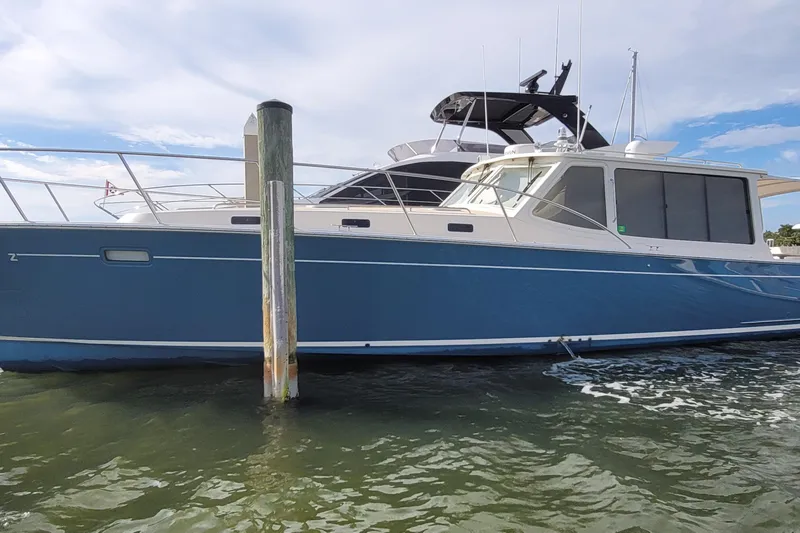 Future 7 Yacht Photos Pics 2018 MJM 50z yacht docked on calm water under a partly cloudy sky.