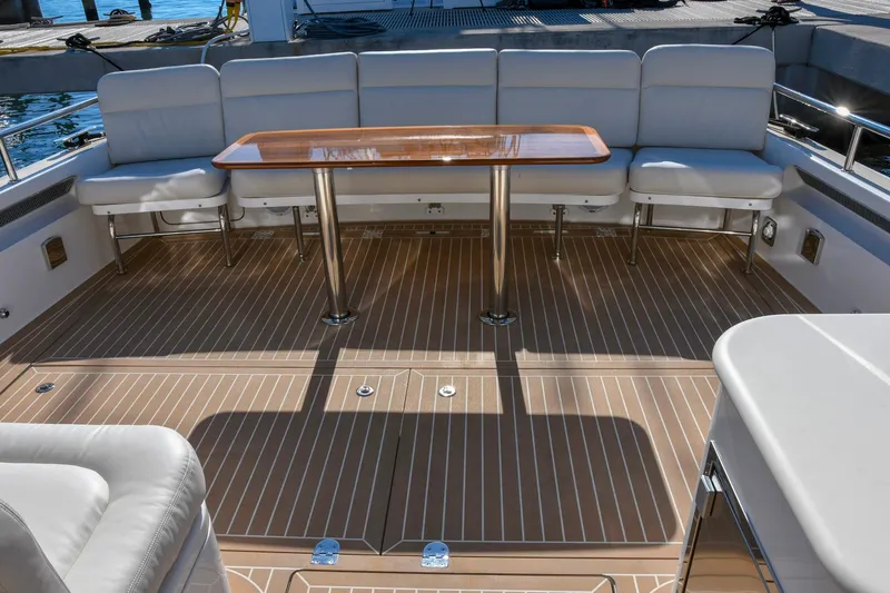 Future 7 Yacht Photos Pics Luxurious 2018 MJM 50z yacht deck with elegant seating and wooden table.