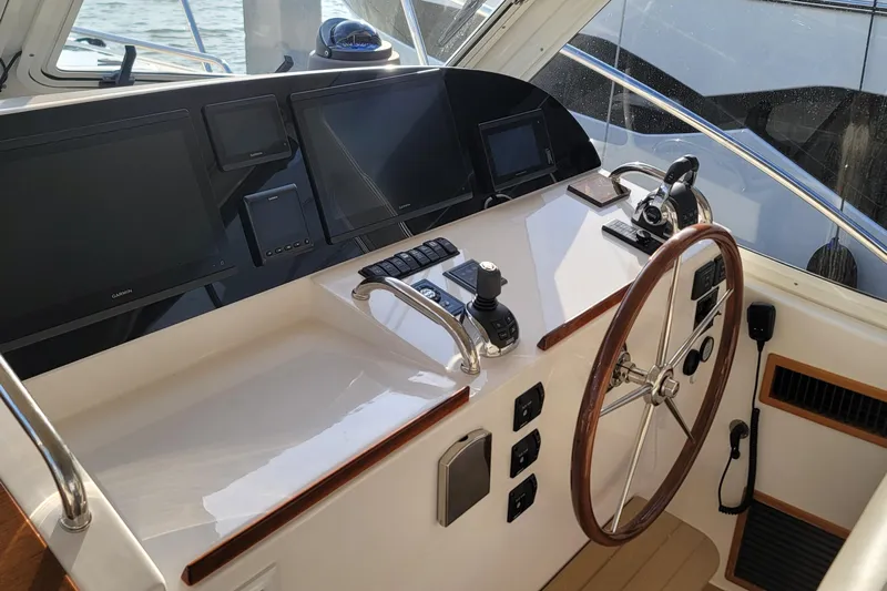 Future 7 Yacht Photos Pics Helm of 2018 MJM 50z yacht with modern navigation equipment and wooden steering wheel.