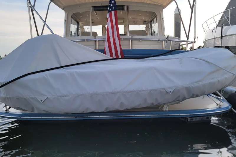 Future 7 Yacht Photos Pics 2018 MJM 50z yacht with covered dinghy and American flag at dock.