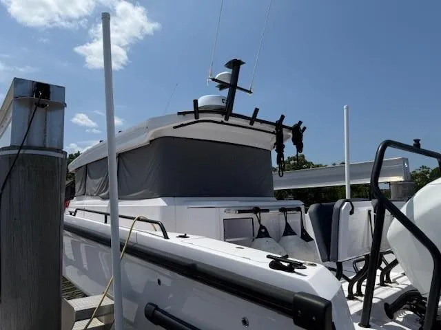  Yacht Photos Pics 2021 Axopar 37 XC CROSS CABIN boat docked under clear blue sky.