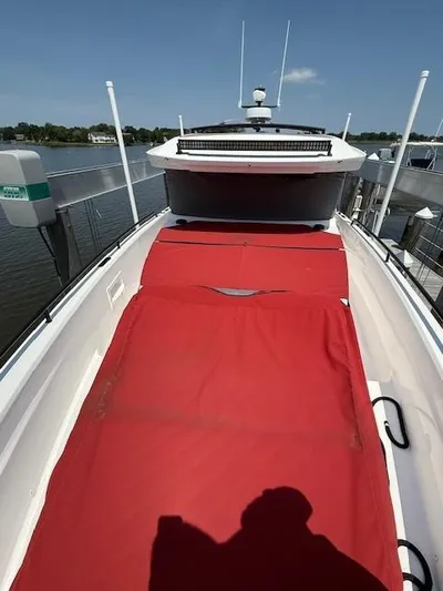  Yacht Photos Pics 2021 Axopar 37 XC CROSS CABIN with red deck cover, docked by the water.
