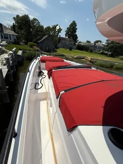  Yacht Photos Pics 2021 Axopar 37 XC CROSS CABIN with red covers docked by waterfront homes.