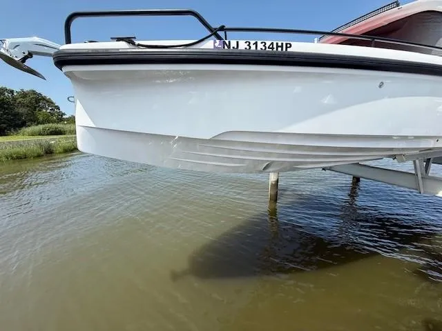  Yacht Photos Pics 2021 Axopar 37 XC CROSS CABIN boat on lift, partially above water.