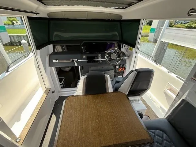  Yacht Photos Pics Interior of 2021 Axopar 37 XC CROSS CABIN, featuring helm and seating area.