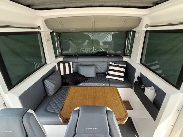  Yacht Photos Pics Interior of 2021 Axopar 37 XC CROSS CABIN with cozy seating and table.