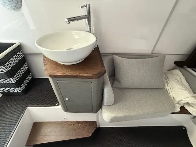  Yacht Photos Pics Modern interior of 2021 Axopar 37 XC CROSS CABIN with sink and seating area.
