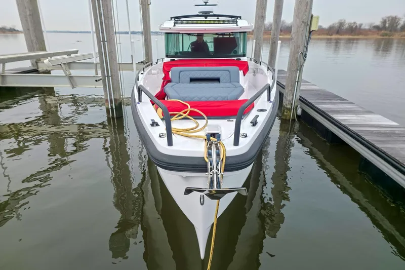  Yacht Photos Pics 2021 Axopar 37 XC Cross Cabin boat docked, featuring red and gray seating.