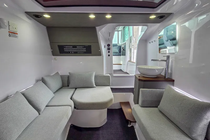  Yacht Photos Pics Luxurious interior of 2021 Axopar 37 XC Cross Cabin with modern seating and sink.