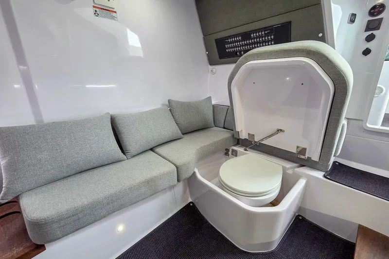  Yacht Photos Pics 2021 Axopar 37 XC Cross Cabin interior with convertible seating and hidden toilet.