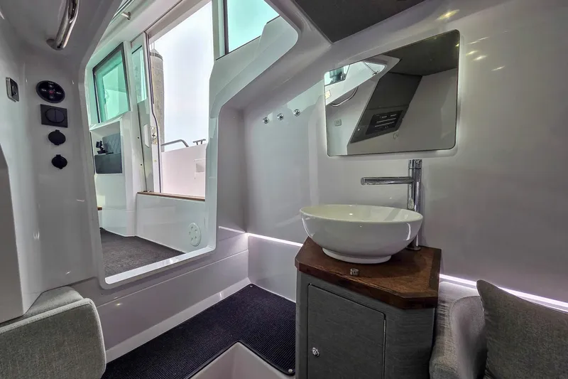  Yacht Photos Pics Interior of 2021 Axopar 37 XC Cross Cabin with modern sink and mirror.