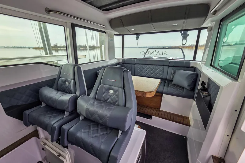  Yacht Photos Pics Interior of 2021 Axopar 37 XC Cross Cabin with luxurious seating and panoramic windows.