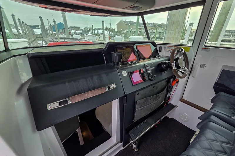  Yacht Photos Pics Interior view of 2021 Axopar 37 XC Cross Cabin helm with modern controls.