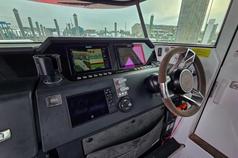  Yacht Photos Pics 2021 Axopar 37 XC Cross Cabin helm with advanced navigation displays and steering wheel.