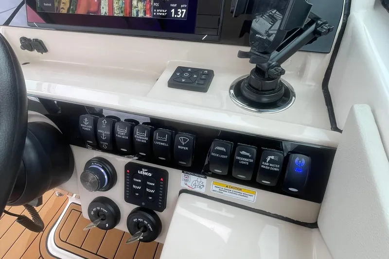 Why Wouldn't You Yacht Photos Pics Control panel of 2023 Boston Whaler 280 Vantage boat with various switches and displays.