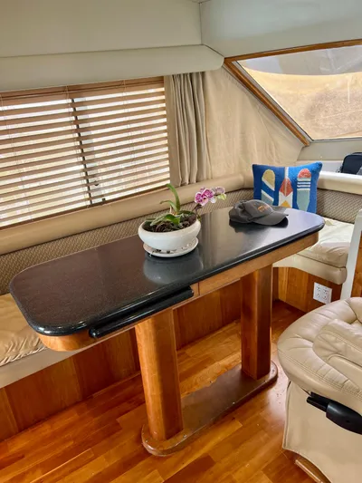 Knot 2 Late Yacht Photos Pics Luxurious interior of 2003 Navigator 57 Rival yacht with wooden table and seating area.