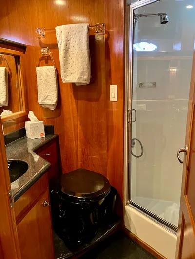 Knot 2 Late Yacht Photos Pics Navigator 57 Rival 2003 yacht bathroom with shower, toilet, and sink.