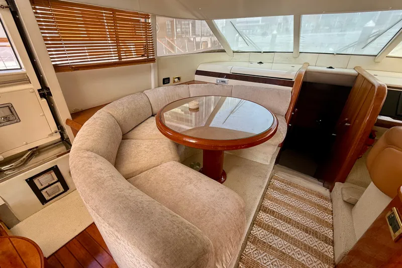  Yacht Photos Pics Luxurious interior of 2000 Fairline Squadron 56 yacht with plush seating and wooden table.