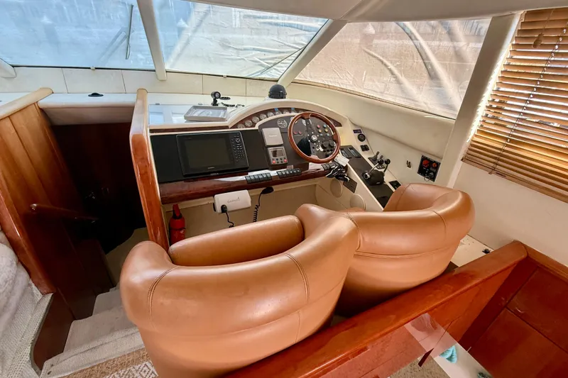  Yacht Photos Pics Luxurious helm of 2000 Fairline Squadron 56 yacht with leather seating and navigation controls.