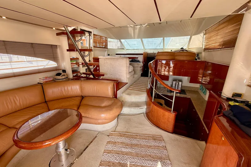  Yacht Photos Pics Luxurious interior of 2000 Fairline Squadron 56 yacht with leather seating and wooden accents.