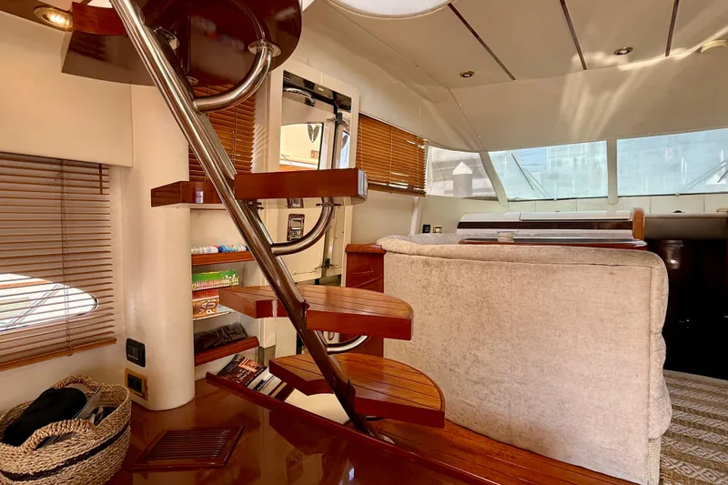  Yacht Photos Pics Interior of 2000 Fairline Squadron 56 yacht with wooden stairs and cozy seating area.