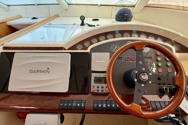  Yacht Photos Pics Cockpit of 2000 Fairline Squadron 56 yacht with Garmin navigation system and wooden steering wheel.