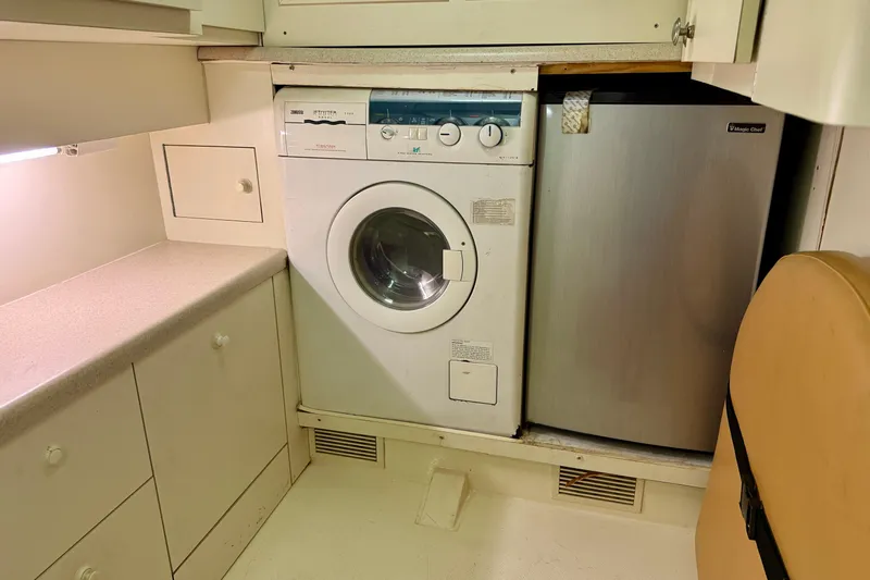  Yacht Photos Pics Laundry area in 2000 Fairline Squadron 56 yacht with washer and mini fridge.